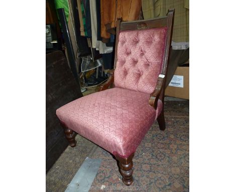 An Edwardian Mahogany framed fireside Chair having turned front legs and upholstered in pink arch patterned Dralon type fabri
