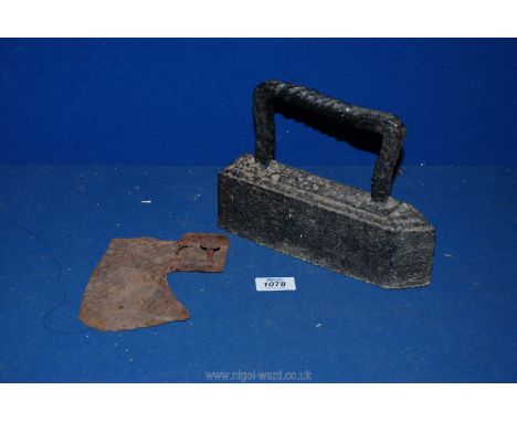 A very old Axe Head with original nails attached and a very heavy flat Iron with twisted handle.