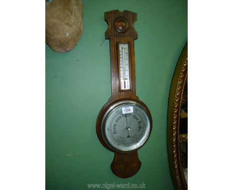 A carved Oak Banjo Barometer/thermometer, 25'' long.