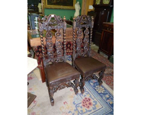 A pair of darkwood framed high back Hall Chairs of early design, the backs with mirrored twist supports, the top rails and sp