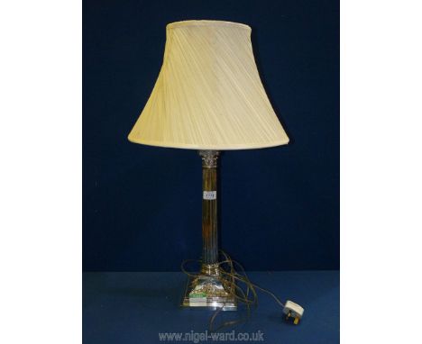 A white metal high gloss finish table lamp in the form of a Corinthian column with base decorated with swags and garlands, 17