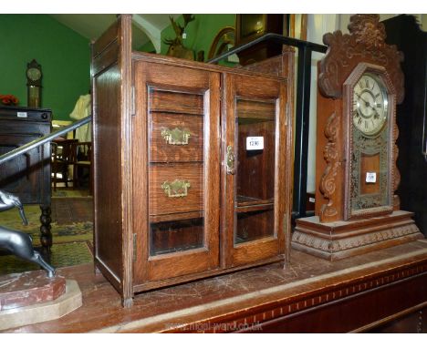 A Smokers cabinet with three drawers, side and lower shelf, with bevelled glass doors and plaque to the top presented to Mr T