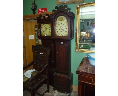 An Oak cased eight day Longcase Clock, the arched painted face decorated with fruit and flowers and having Roman numerals, in