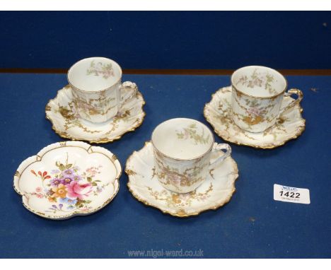 Three Limoges coffee cans and saucers with gold highlighted embossed detail and a Crown Derby 'Derby Posies' trinket dish.