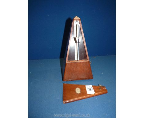 A cased Metronome by Paquet, 9'' tall.