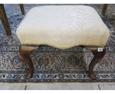 A walnut piano stool with cabriole legs 