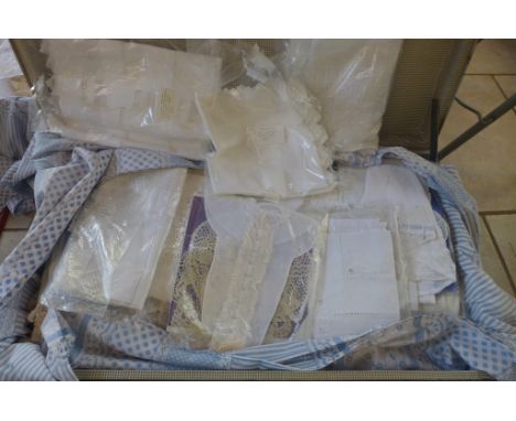 A trunk full of assorted vintage linen and lace work including trim and table cloths 