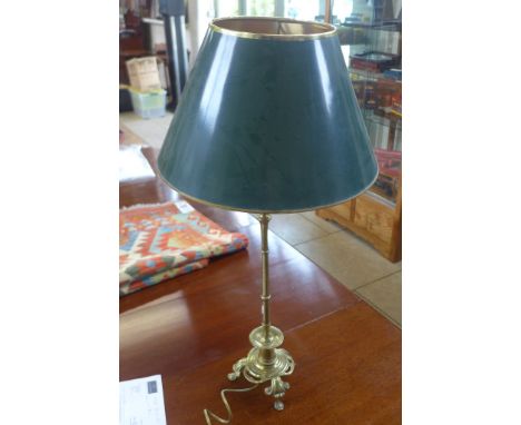 A brass table lamp with tri-form base, 82cm tall with shade 