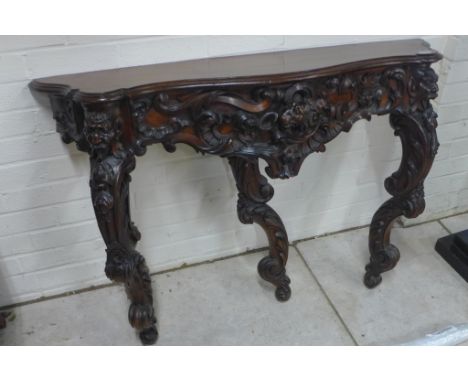 A well carved early 19th century walnut console table, 117cm x 80cm 