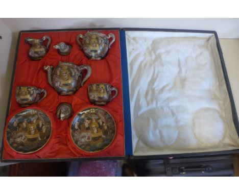 A Satsuma tea for two set, with dragon handles and dragon and sage decoration, with travel box, generally good, one small chi