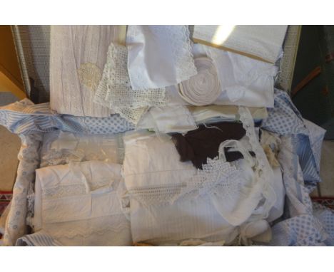 A trunk full of assorted vintage linen and lace work including trim and table cloths 