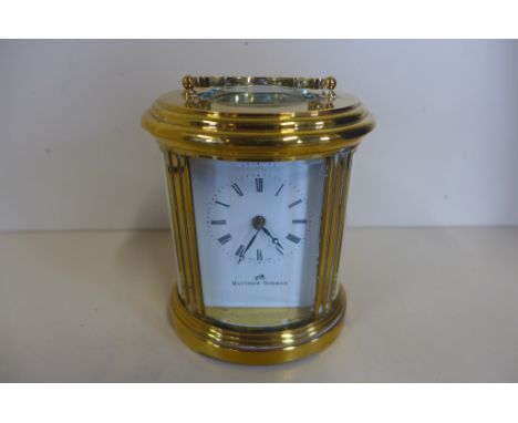 An oval brass carriage clock by Matthew Norman, with key, in good condition, running order 