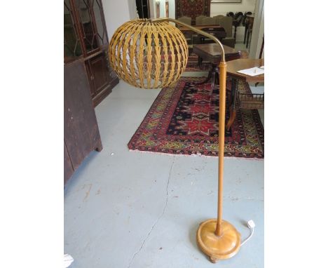 An Ercol standard reading lamp with wicker shade, 140cm tall 