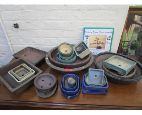 A collection of ceramic Bonsai trays and a book on Creating Your Own Bonsai 