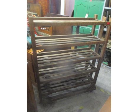 A vintage pine six tier rack on four castors 54 1/4"h x 41 1/2"w 