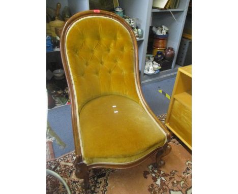 A Victorian walnut button back nursing chair on two front cabriole legs 