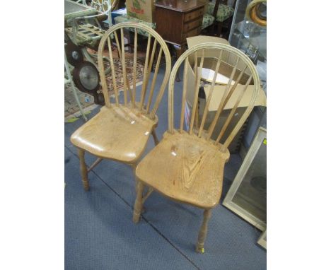 A pair of light elm seated Windsor stick back chairs 