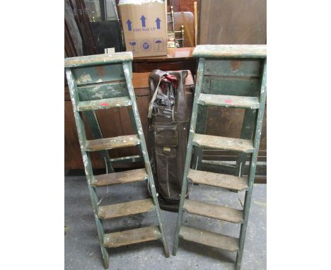 A Wizard De Lux golf club set in a brown golf bag and two vintage green painted folding wooden ladders 
