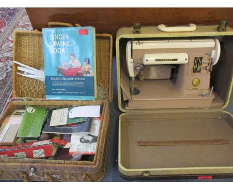 A vintage cased Singer 301A together with a basket of Singer sewing machine accessories and ephemera 