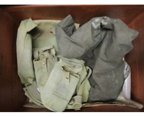 A vintage tin metal trunk containing various army bags to include a kit bag, belts, pouches, three other empty tin trunks and
