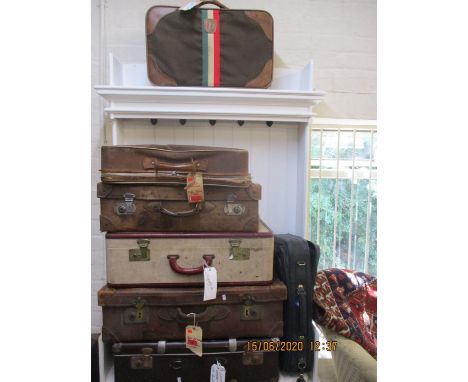 Eight vintage suitcases to include leather examples 