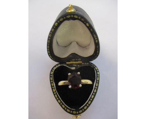 An 18ct gold ring set with a ruby, stamped 750, 3.4g 