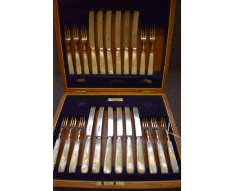 An oak cased set of silver and mother of pearl dessert knives and forks, by Cooper Brothers &amp; Sons, Sheffield 1917, (one 