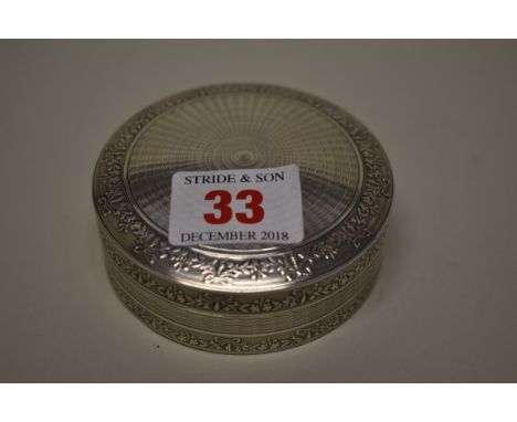 A silver circular engine turned box,&nbsp;by William Base &amp; Sons, Birmingham 1922, 7.5cm diameter, 80.5g. 