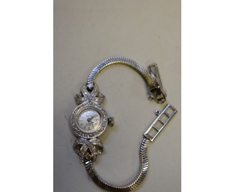 A vintage Pallas ladies 18ct white gold and diamond set manual cocktail watch, having 9ct white gold bracelet.