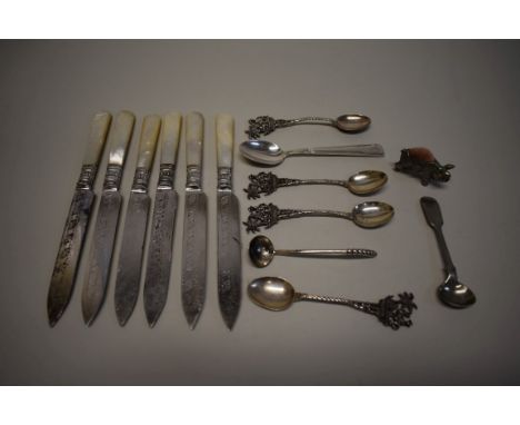 A set of six silver plated knives, with mother of pearl handles; together with a plated novelty pig pin cushion; and a small 