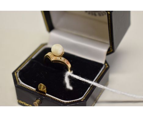 A 14k gold pearl and diamond chip ring. 