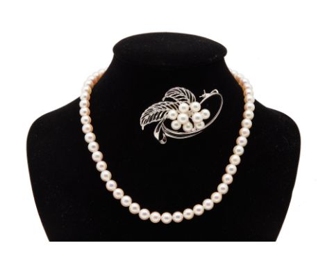 AN AKOYA CULTURED PEARL NECKLACE &amp; BROOCH
With 55 pearls in total, measuring 7.0mm-7.5mm
The brooch and necklace marked '