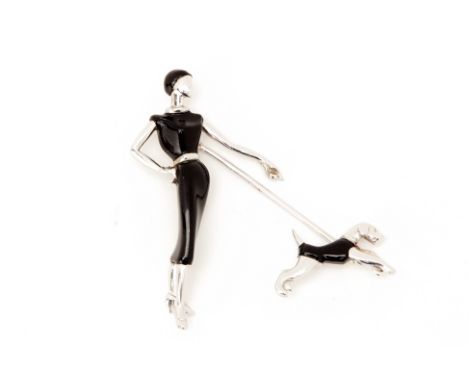 AN ART DECO WHITE GOLD AND BLACK ENAMEL PIN BROOCH
Attributed to Van Cleef &amp; Arpels
Modelled as an elegant lady in a blac