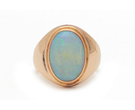 AN OPAL RING
Set in 18k yellow gold, with a central bezel set and oval cut opal
US 6.6
7.6g
Condition: For a condition report