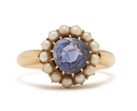 AN ANTIQUE SAPPHIRE AND PEARL CLUSTER RING
The native-cut cornflower blue sapphire, probably Sri Lankan, within a surround of