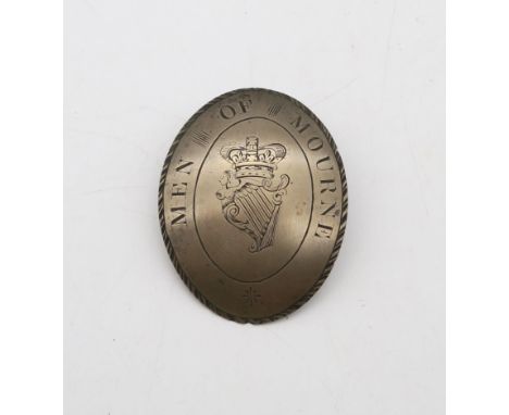 An early-19th century badge or buckle, hand-engraved "Men of Mourne" surrounding a crowned Irish Harp, likely related to the 