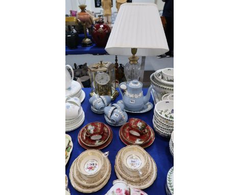 A pair of Paragon trio's decorated with bouquets of flowers, a pair of Noritake trios with extra saucers, a Wedgwood Queens W