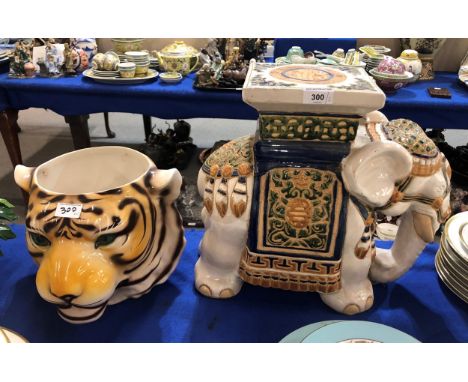A tigers head planter and an elephant plant stand Condition Report:Available upon request