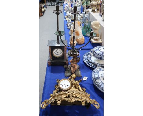 A pair of tall candlesticks, a cherub candelabra, a slate mantle clock and a gilt metal clock Condition Report:Available upon