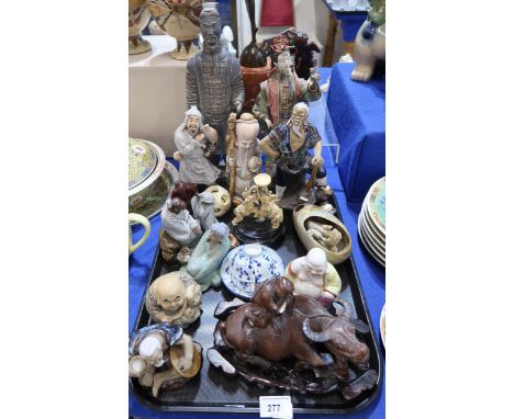 A collection of ceramics including Chinese figures of scholars and fishermen, a Buddha, a carved wooden figure of a boy ridin