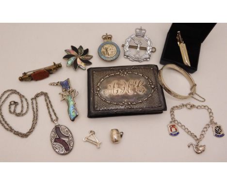 A silver mounted early 20th century mini photo album, A Royal Observer Corps Sweetheart brooch and cap badge, A child's bangl