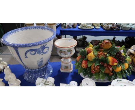A large Italian ceramic fruit basket centre piece, together with two pottery jardinieres on stands Condition Report:Available