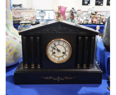 A slate mantel clock with column decorated front and portico frieze Condition Report:Available upon request
