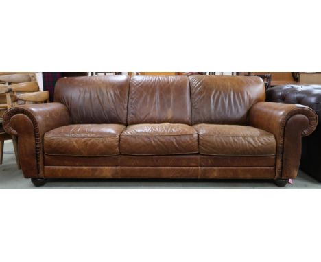 A contemporary Italian leather upholstered three seater sofa on turn feet, 85cm high x 233cm wide x 105cm deep Condition Repo