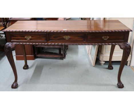 A 20th century mahogany console table with rectangular top with gadrooned edges over three drawers on carved cabriole ball an