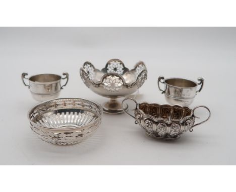 A silver bon bon dish, by Mappin &amp; Webb, the body with pierced openwork, a pair of silver salts, modelled as trophy cups,