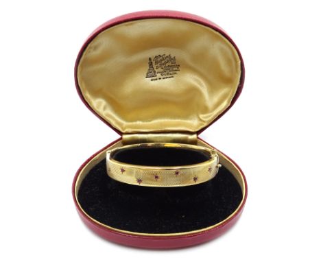 9ct gold hinged bangle set with rubies, engine turned decoration, Chester 1958 Condition Report 22gm
