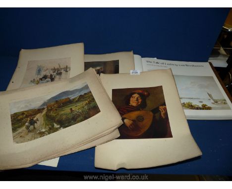 A box of unframed prints and a book.