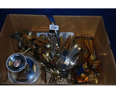 A quantity of gold plated cutlery, candle holder, plus soup ladle.