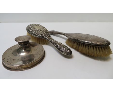 A silver inkwell with large weighted circular base, Birmingham 1919, together with two silver backed hair brushes
